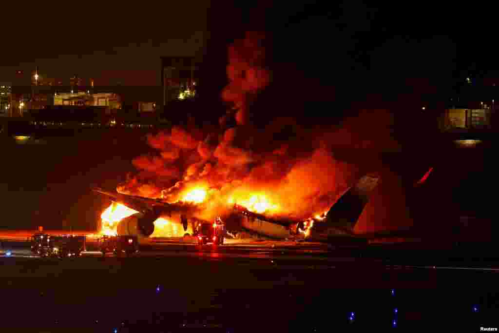 Japan Airlines' A350 airplane is on fire at Haneda international airport in Tokyo. All 379 people aboard the plane escaped the burning airliner after a collision with a Coast Guard aircraft at the airport that killed five of six crew on the smaller craft.