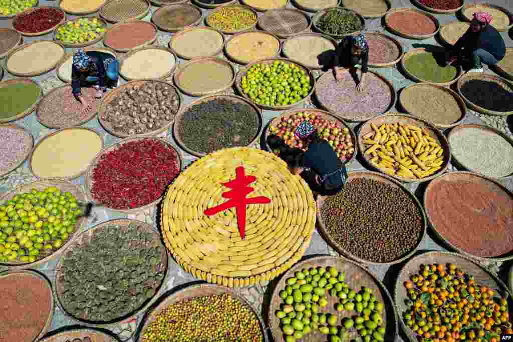 Farmers dry crops during the harvest season in Linyi, in China's eastern Shandong province.