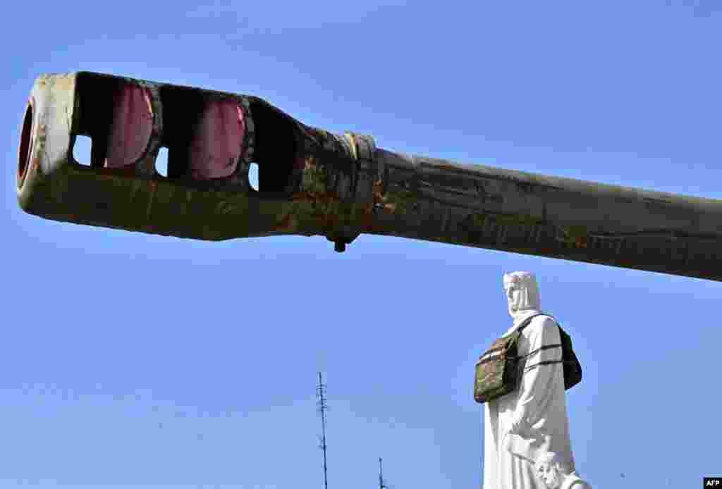 The Princess Olga monument is seen in a dummy bulletproof vest with a sign reading, "She needs armour," to draw attention to the need of armor designed specifically for women, at an open-air exhibition of destroyed Russian armored vehicles in Kyiv, Ukraine.