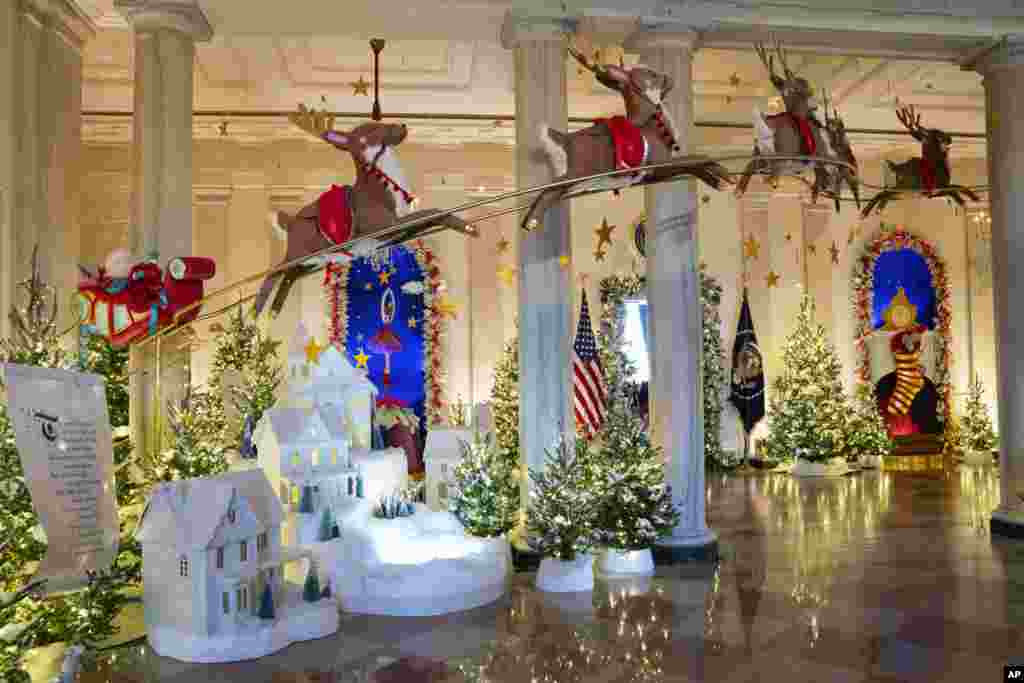 Holiday decorations adorn the Grand Foyer of the White House for the 2023 theme "Magic, Wonder, and Joy" in Washington.