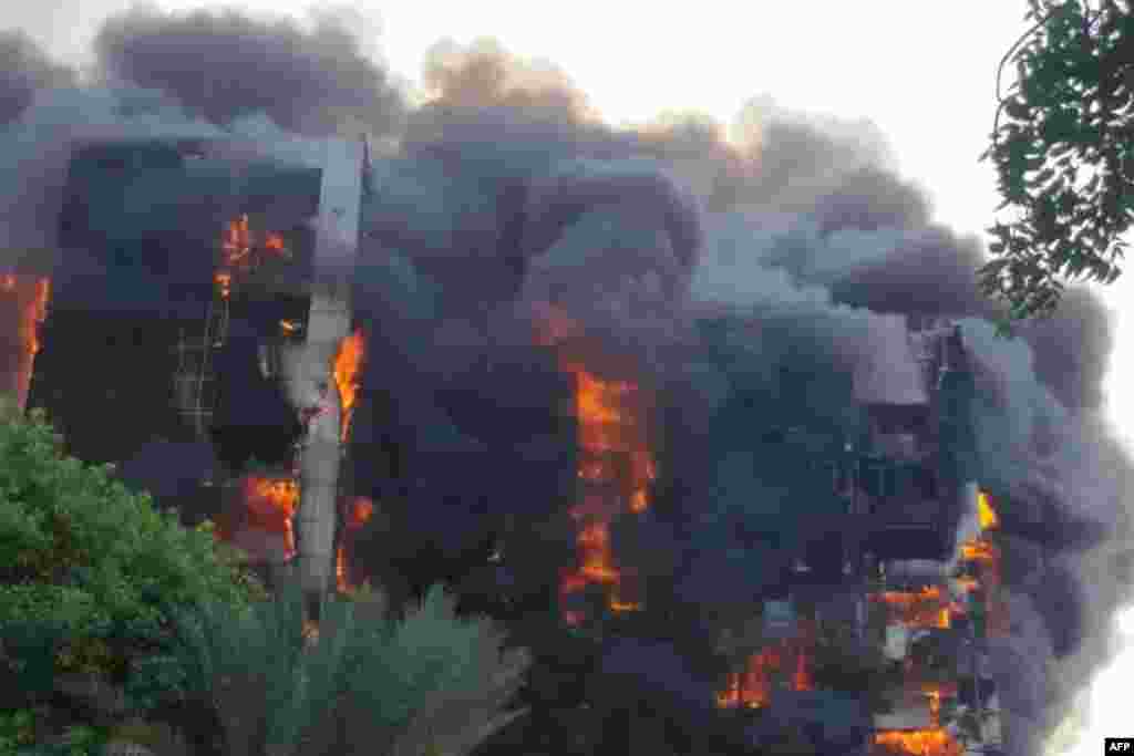 A fire rages at the Greater Nile Petroleum Oil Company Tower in Khartoum, Sudan. Battles between the regular army and the paramilitary Rapid Support Forces, which intensified Sunday, had set fire to several key buildings in the center of the capital. 