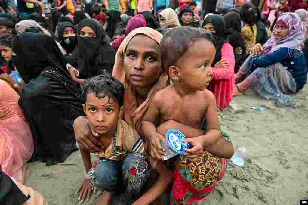 Newly-arrived Rohingya refugees wait to be transferred to a shelter in Batee beach, Aceh province. At least 147 Rohingya refugees, mostly women and children, landed in Indonesia's westernmost province.
