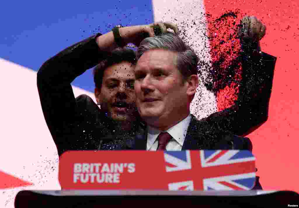 A protester throws confetti on Britain's Labour Party Leader Keir Starmer at the party's annual conference in Liverpool.