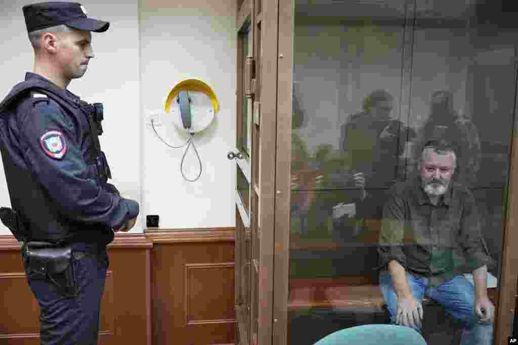Igor Girkin, also know as Igor Strelkov, the former military chief for Russia-backed separatists in eastern Ukraine, sits in a glass cage in a courtroom at the Moscow's City Court in Moscow, Russia. A prominent Russian hard-line nationalist who accused President Vladimir Putin of weakness and indecision in Ukraine was detained on charges of extremism. 