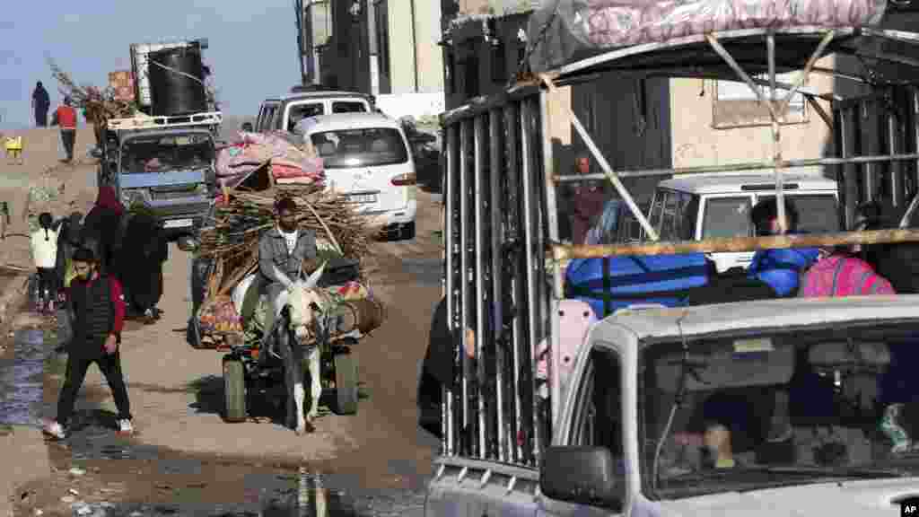 Palestinians flee the Israeli ground offensive in the central Gaza Strip, heading south through Deir al Balah.