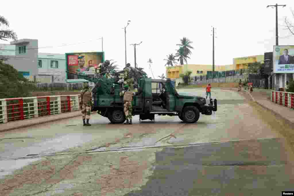 Soldiers of the Republican Guard stand on their armed pick-up in a street in Libreville, Gabon. A group of senior military officers said they had seized power minutes after the Central African state's election body announced that President Ali Bongo had won a third term.