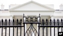 FILE - The White House is visible through the fence at the North Lawn in Washington, on June 16, 2016. A driver died Saturday night, May 4, 2024 after crashing a vehicle into a gate at the White House, authorities said.