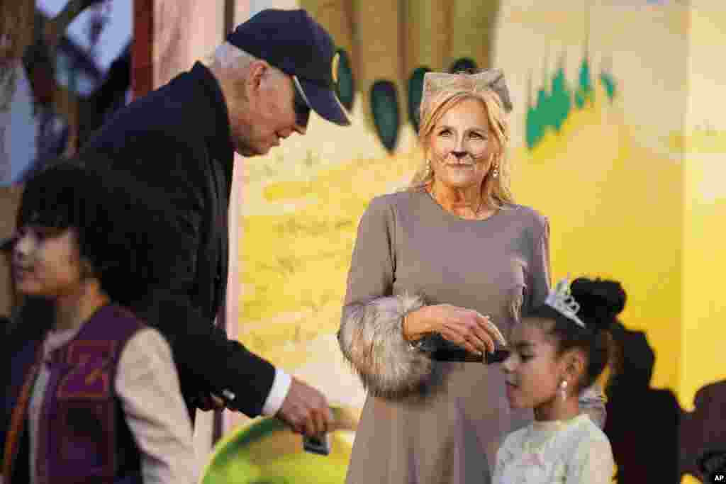 President Joe Biden and first lady Jill Biden give treats to trick-or-treaters on the South Lawn of the White House, on Halloween, Oct. 30, 2023.