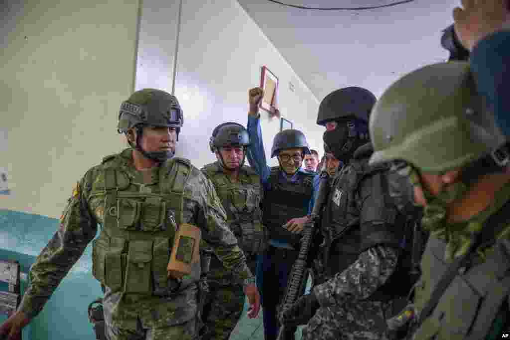 Security forces escort presidential candidate Christian Zurita after he voted in a snap election in Quito, Ecuador. 