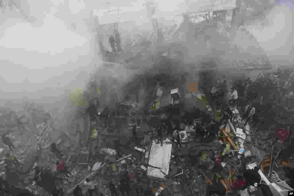 Palestinians look for the survivors following an Israeli strike in Rafah, Gaza Strip.