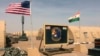 FILE - U.S. and Nigerien flags are raised at Air Base 201 in Agadez, Niger, April 16, 2018. Air Base 201 is one of two bases U.S. troops have used while stationed in Niger.