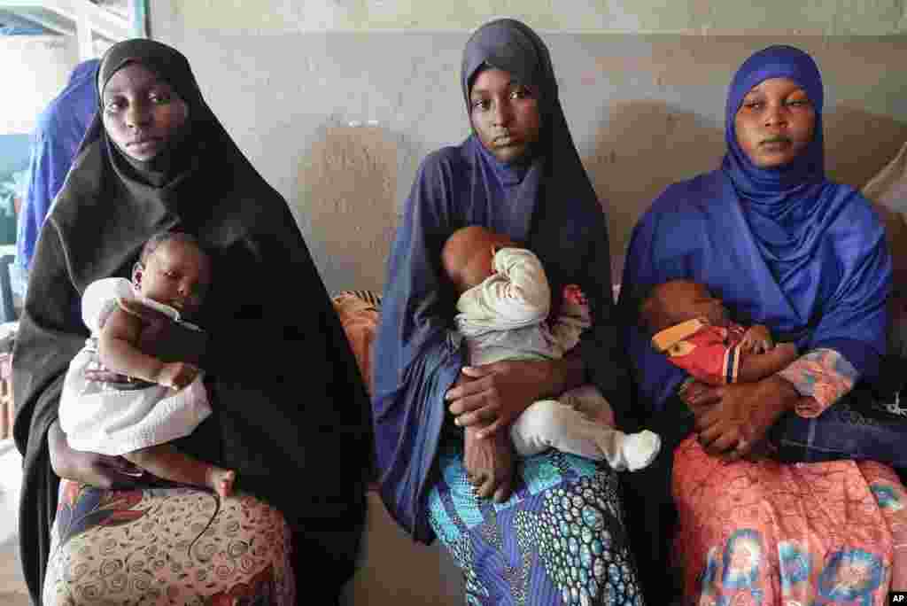 Women gather at a clinic to have their children vaccinated in Niamey, Niger. Severe economic and travel sanctions, imposed by the West African regional bloc ECOWAS after mutinous soldiers ousted the country's democratically elected president in July, are taking a toll on Nigeriens.