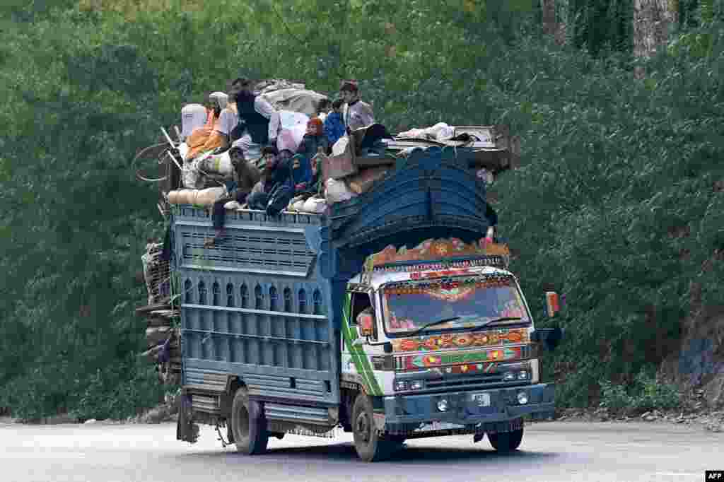 Afghan refugees arrive in trucks to cross the Pakistan-Afghanistan border in Torkham. Islamabad has given Afghans it has deemed to be living illegally in Pakistan until November 1 to leave voluntarily or face deportation — an order the Taliban government says amounts to harassment. 