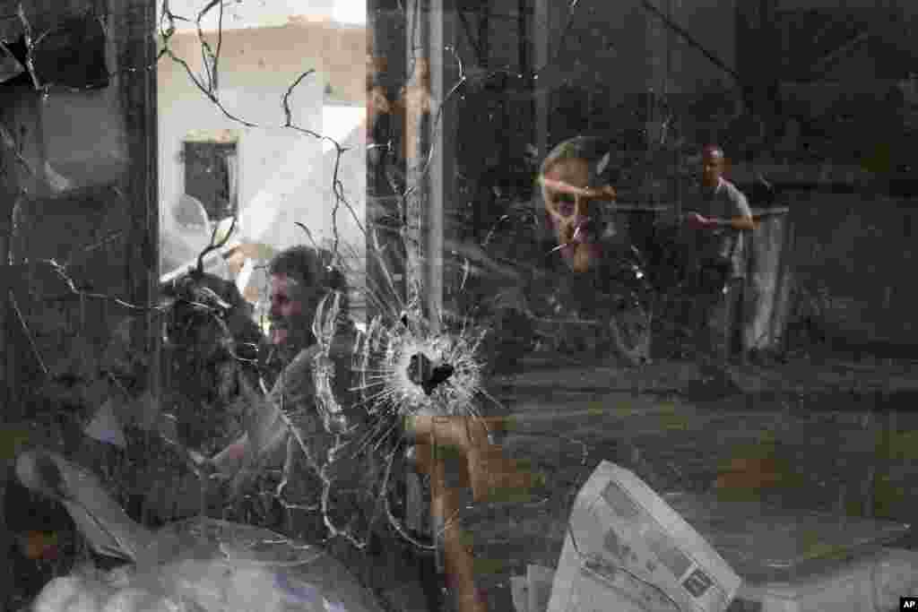 A bullet hole is seen in a shop window following an Israeli military raid in the Jenin refugee camp, West Bank. Palestinian health officials say the death toll over a day of fighting between Israel and the Palestinians in the occupied West Bank and the Gaza Strip has risen to six, four from Jenin. 