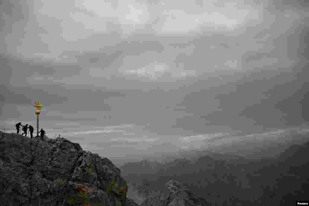Mountaineers walk on Germany's highest peak, the Zugspitze mountain near Garmisch-Partenkirchen.