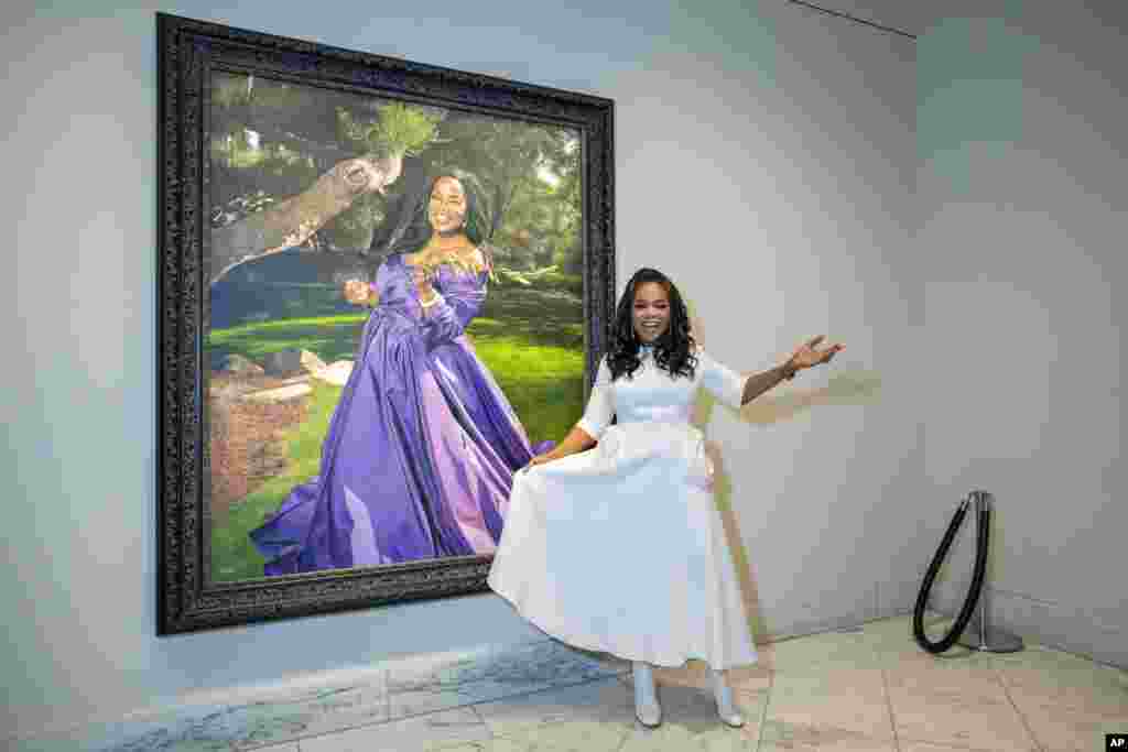 Oprah Winfrey stands next to her newly installed portrait in the Smithsonian's National Portrait Gallery during a portrait unveiling ceremony in Washington.