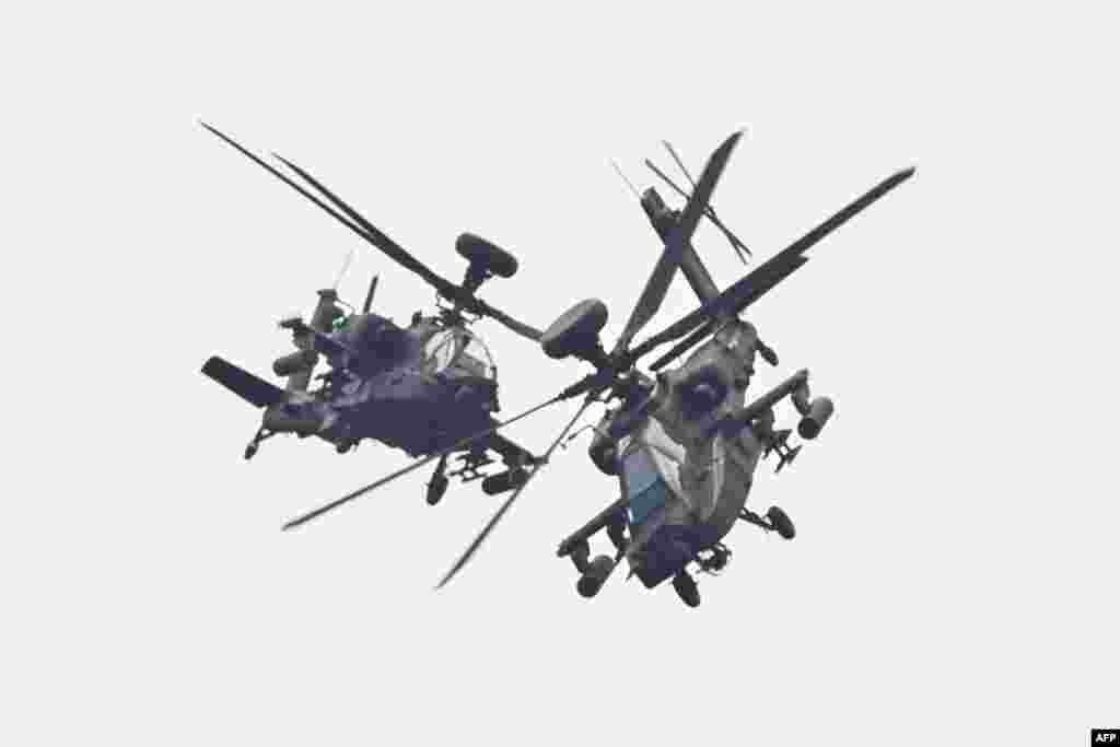 Two U.S.-made Apache attack helicopters, from Taiwan's Army Airborne Special Forces, demonstrate their combat skills during a military open house event in Hsinchu, Taiwan.