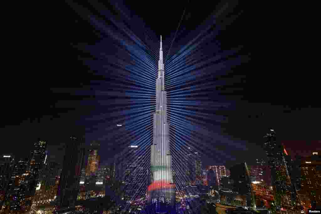 The colors of the United Arab Emirates flag are projected onto the Burj Khalifa, the tallest building in the world, during New Year's Eve celebrations in Dubai, United Arab Emirates, Dec. 31, 2023.
