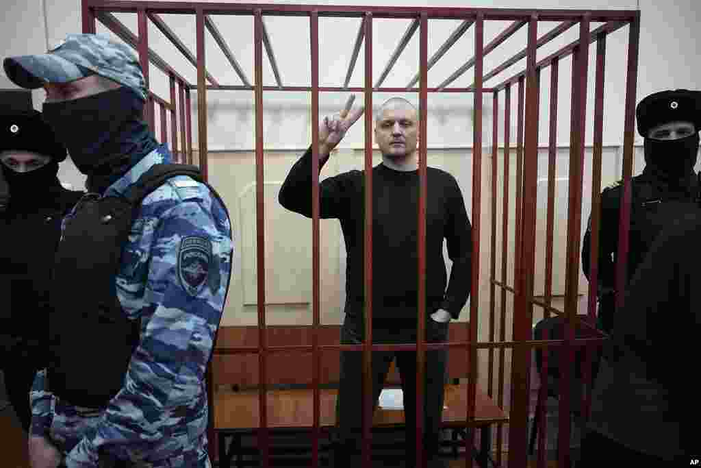 Sergei Udaltsov, Russian left-wing political activist and critic of President Vladimir Putin, stands in a cage in a courtroom in Moscow, Russia.