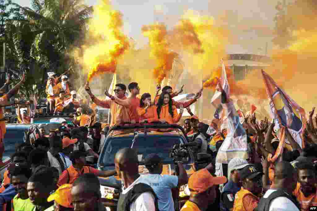 Incumbent Madagascar President Andry Rajoelina, candidate in the 2023 presidential election, his wife Mialy Rajoelina and their three children, ride in a pickup truck to greet supporters during his re-election campaign, in Toamasina, Nov. 11, 2023.