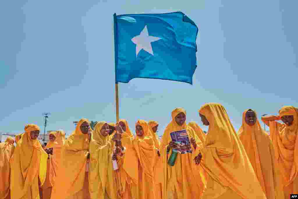 Students wave a Somali flag during a demonstration in support of Somalia's government following the port deal signed between Ethiopia and the breakaway region of Somaliland at Eng Yariisow Stadium in Mogadishu. Somalia vowed to defend its territory after a controversial Red Sea access deal between Ethiopia and the breakaway state of Somaliland that it branded as "aggression." 
