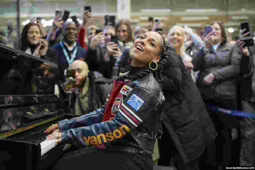Alicia keys performs on Elton John's piano during a surprise performance at Kings Cross station in London.