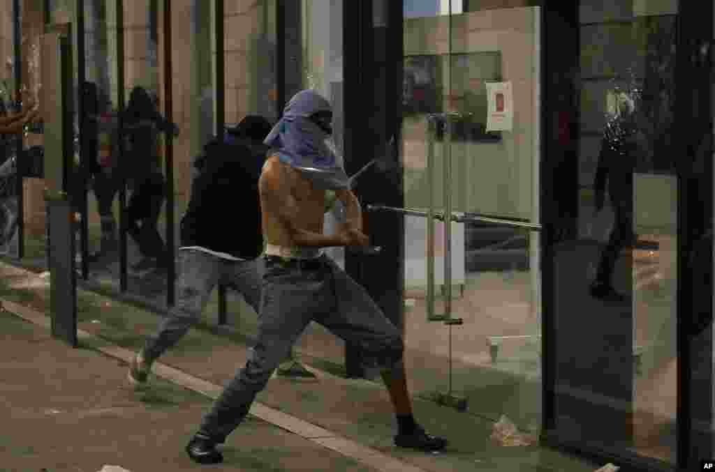 Demonstrators attack a building in downtown Guatemala City during a national strike, Oct. 9, 2023. People are protesting to support President-elect Bernardo Arévalo after Guatemala's highest court upheld a move by prosecutors to suspend his political party over alleged voter registration fraud.
