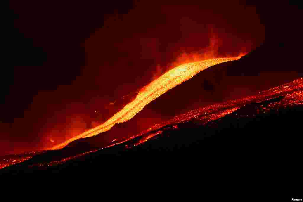 Lava flows downhill as Mount Etna erupts, as seen from Pizzi Deneri on the north side of volcano, on the island of Sicily, in Catania, Italy, May 31, 2022.