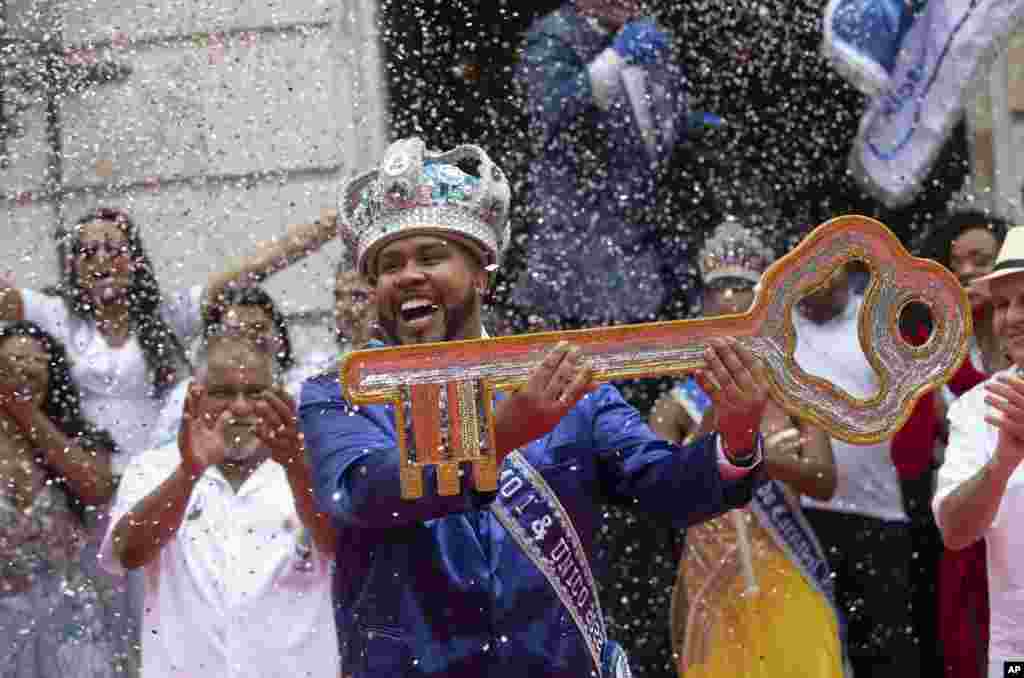 Carnival King Momo, Wilson Dias da Costa Neto, holds up the key of the city during a ceremony marking the official start of Carnival in Rio de Janeiro, Brazil.