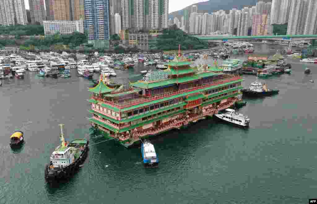 An aerial photo shows Hong Kong's Jumbo Floating Restaurant, an iconic but aging tourist attraction designed like a Chinese imperial palace, being towed out of Aberdeen Harbor, after its popularity dimmed in recent years even before the coronavirus hit.
