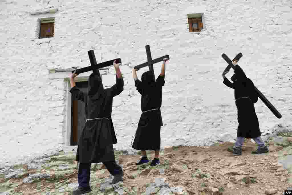 Penitents carry crosses during the "Romeria a la Trinidad" pilgrimage in the village of Lumbier, Spain,.