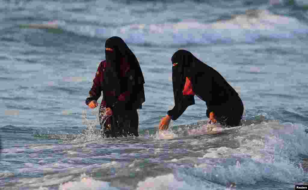 Palestinians enjoy the beach in Gaza City, June 8, 2022.