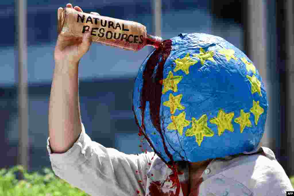 An activist from the climate change protest group Extinction Rebellion takes part in a demonstration to draw attention to missing UK journalist Dom Phillips and Brazilian Indigenous affairs specialist Bruno Pereira, near the European Commission building in Brussels.