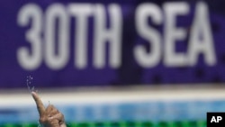 Philippines' Juan Paolo Serrano gestures after scoring a goal during their men's water polo match against Singapore at the 30th South East Asian Games in New Clark City, Tarlac province, Philippines, Nov. 29, 2019. 