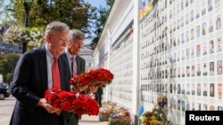 U.S. National Security Adviser John Bolton and U.S. Embassy Charge d'Affairs William Taylor attend a wreath-laying ceremony at the memorial for soldiers killed in a recent conflict in eastern Ukraine, in Kyiv, Ukraine, Aug. 27, 2019.
