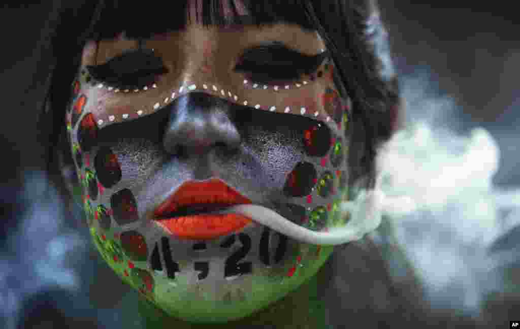 Ana Mendez Casteñeda smokes marijuana during "Fumaton 420" outside the national Senate in Mexico City, April 20, 2021.