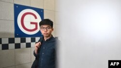 FILE - Pro-democracy activist Joshua Wong arrives at the Southern district office as he requests to meet returning officer Dorothy Ma in Hong Kong, Oct. 24, 2019.