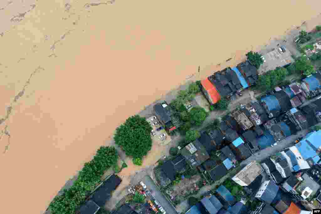 This aerial photo shows a flooded street along the swollen Rongjiang river after heavy rains in Rongan, in China's southern Guangxi region.