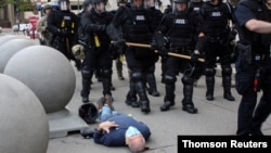 Martin Gugino lays on the ground after he was shoved by two Buffalo, New York, police officers during a protest against the death in Minneapolis police custody of George Floyd in Buffalo, New York