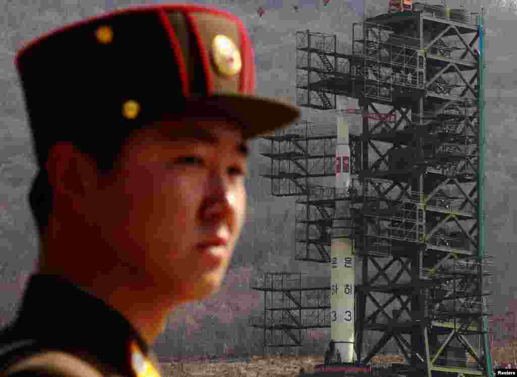 April 8, 2012: A soldier stands guard in front of the Unha-3 rocket sitting on a launch pad at the West Sea Satellite Launch Site, northwest of Pyongyang, North Korea.