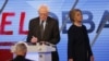 Democratic presidential candidate, Hillary Clinton enters the stage after a break as Democratic presidential candidate, Sen. Bernie Sanders, I-Vt, makes notes, March 9, 2016.