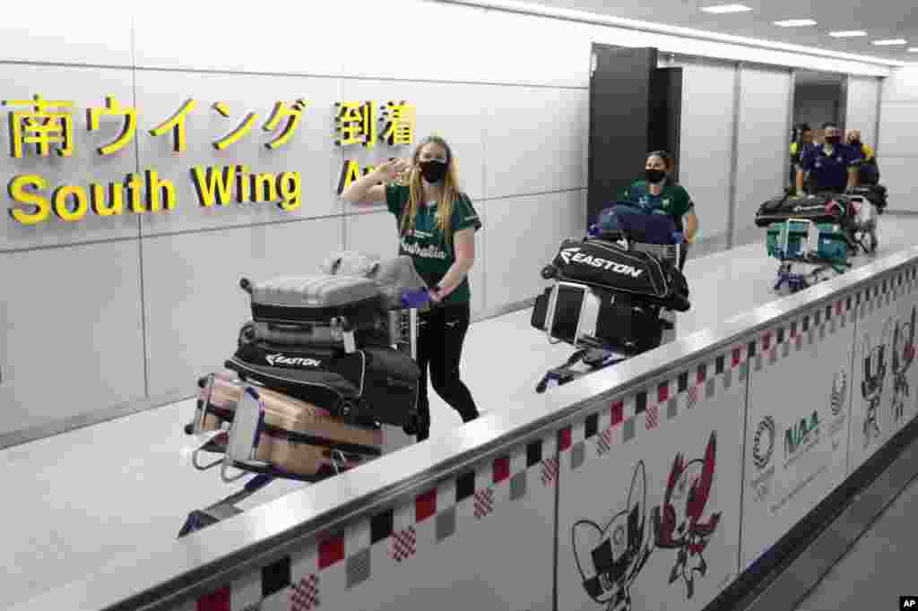Members of Australia's Olympic softball squad, the first national team to come to Japan for pre-Olympic training camp since the Tokyo 2020 Olympic Games were postponed to 2021 due to the COVID-19 pandemic, arrive at Narita international airport in Narita, east of Tokyo.