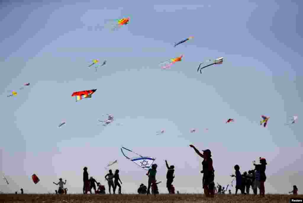 Israelis fly kites during the Rosh Hashanah holiday, the first two days of the Jewish new year, in Beit Guvrin National Park near the city of Kiryat Ga.