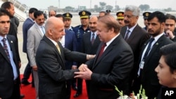 Pakistani Prime Minister Nawaz Sharif, center right, greets Afghan President Ashraf Ghani, center left, upon his arrival at Nur Khan airbase in Rawalpindi, Pakistan, Dec. 9, 2015. 