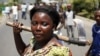 A female protester holds an ax during a protest against Burundian President Pierre Nkurunziza's decision to run for a third term in Bujumbura, Burundi, May 13, 2015.