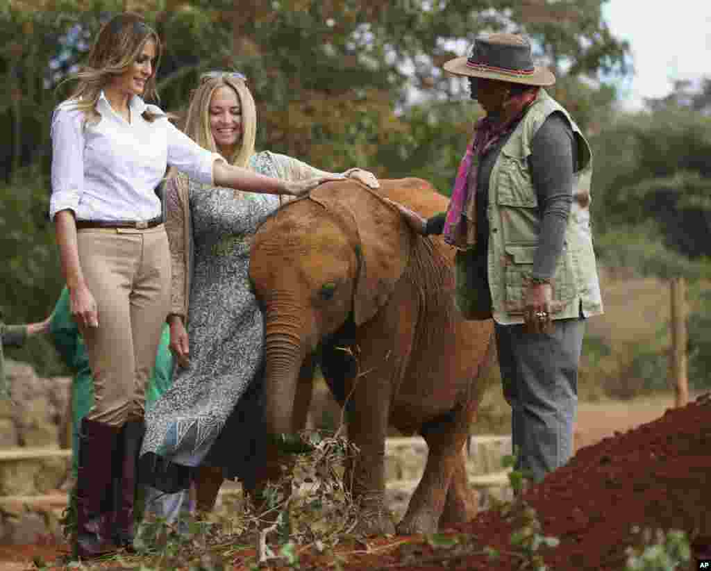 First lady Melania Trump with Margaret Kenyatta, Kenya's first lady, pets a baby elephant the at David Sheldrick Elephant & Rhino Orphanage at Nairobi National Park in Nairobi, Kenya, Oct. 5, 2018.