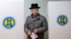 A man leaves a booth before casting his vote during a presidential election at a polling station in Chisinau, Moldova, Oct. 30, 2016. 