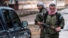 Christian fighters of Sutoro (The Syriac Security Office) carry their weapons as they man a checkpoint in the town of Tel Tamr, Syria, Feb. 25, 2015. 