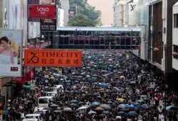 FILE - Anti-government demonstrators attend a protest march in Hong Kong, China, Oct. 20, 2019.