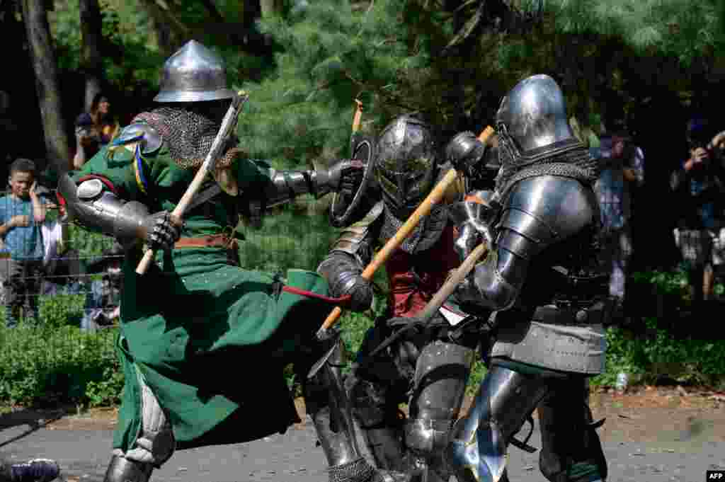 Members of the 'Gladiators NYC' armored combat group fight in Central Park, New York, July 10, 2021.